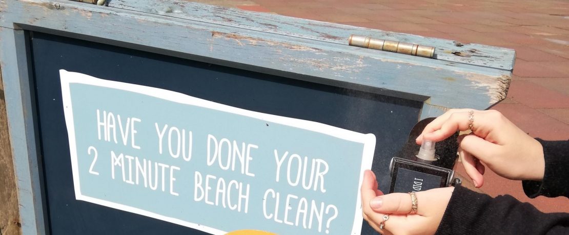 Hand sanitiser being used on a beach clean boards