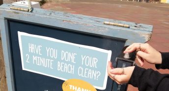 Hand sanitiser being used on a beach clean boards