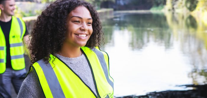 A woman wearing a hi vis vest