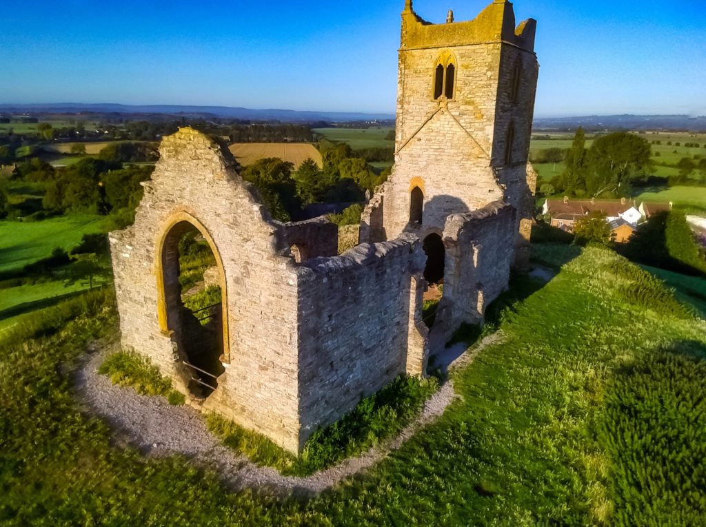 A drone photo of the ruined church on top of Burrow Mump