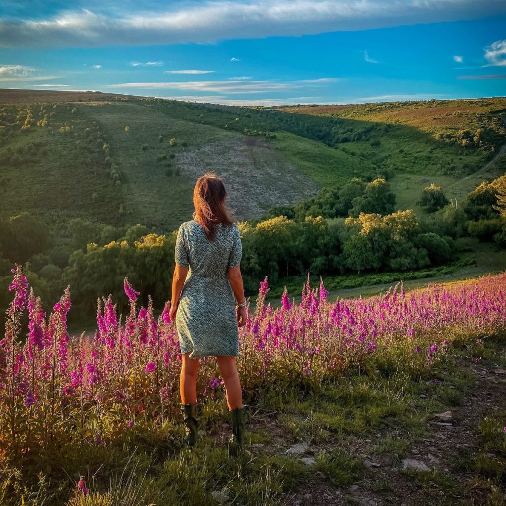 A woman looks over a valley
