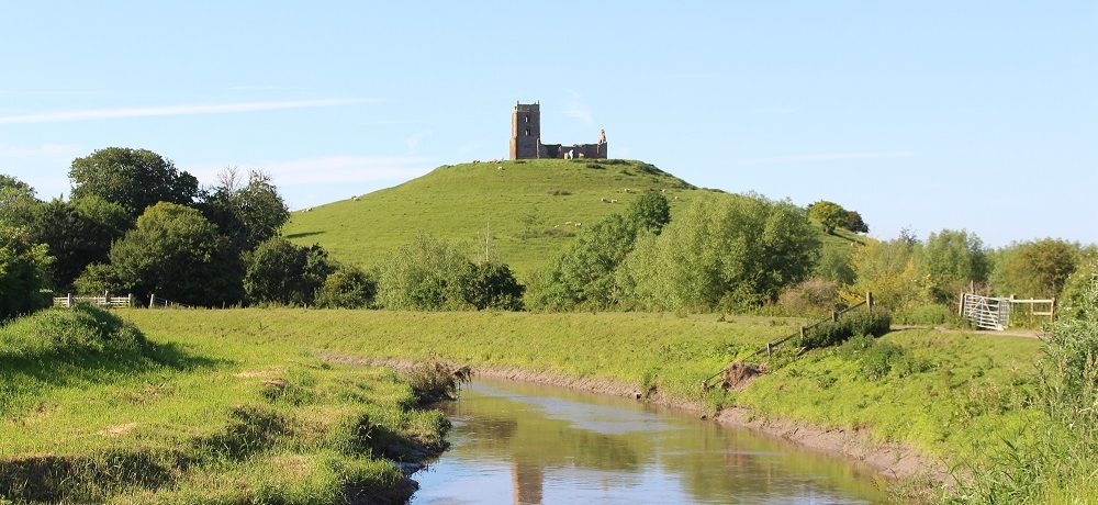 A picture of Burrow Mump with a river in the foreground