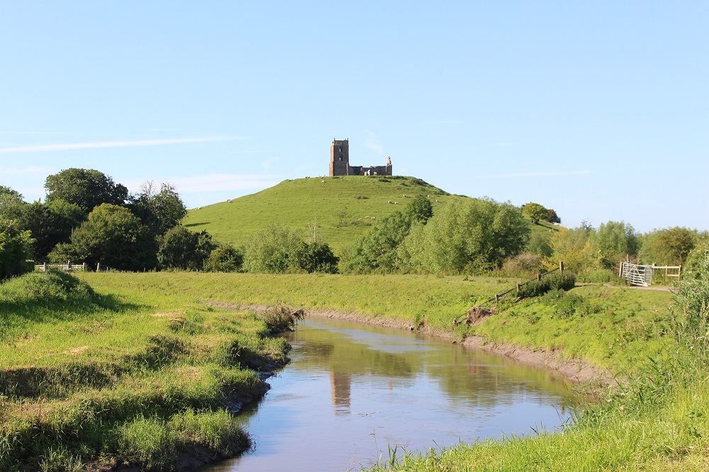 A picture of Burrow Mump with a river in the foreground