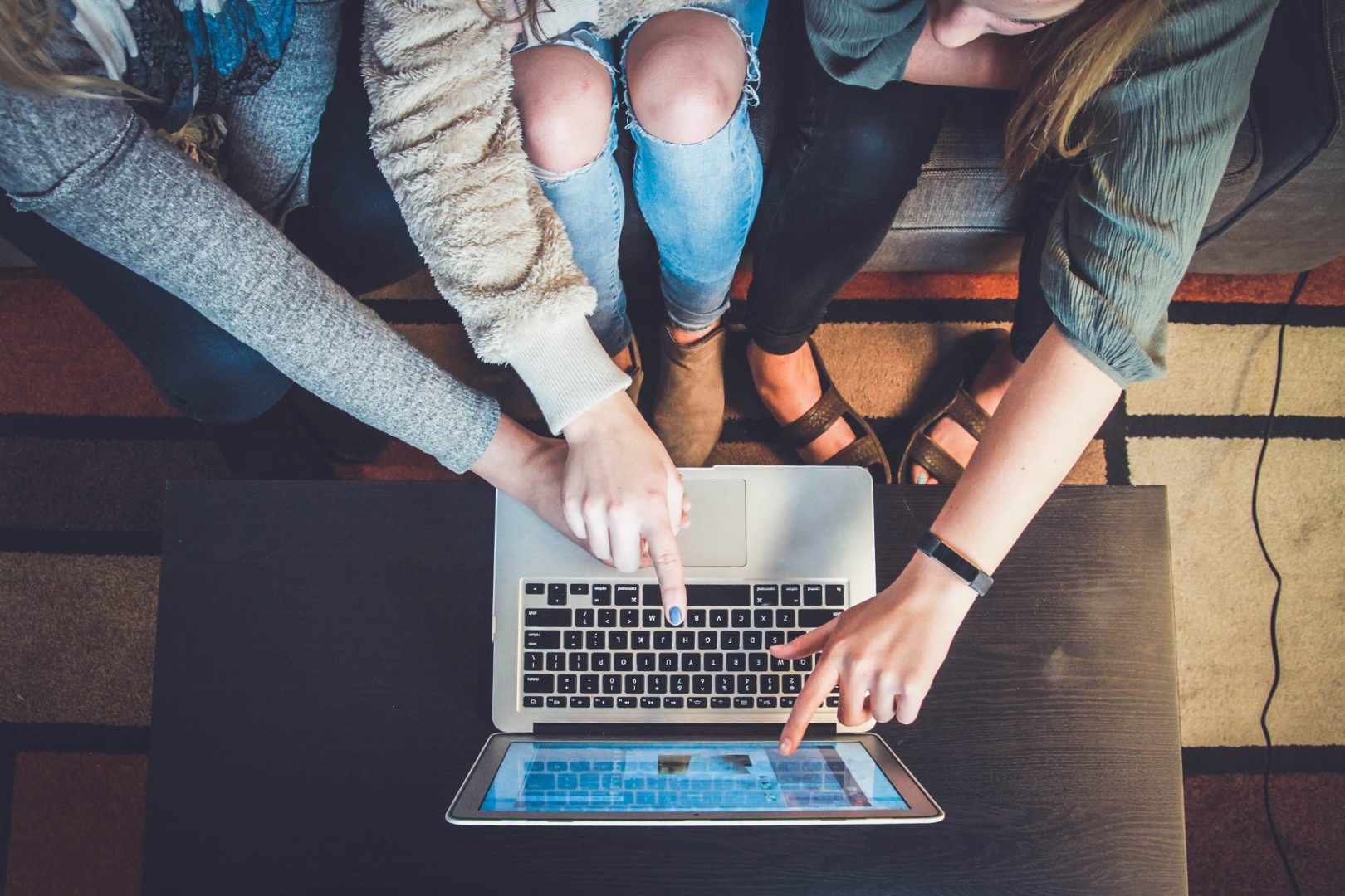 A family point at a laptop screen