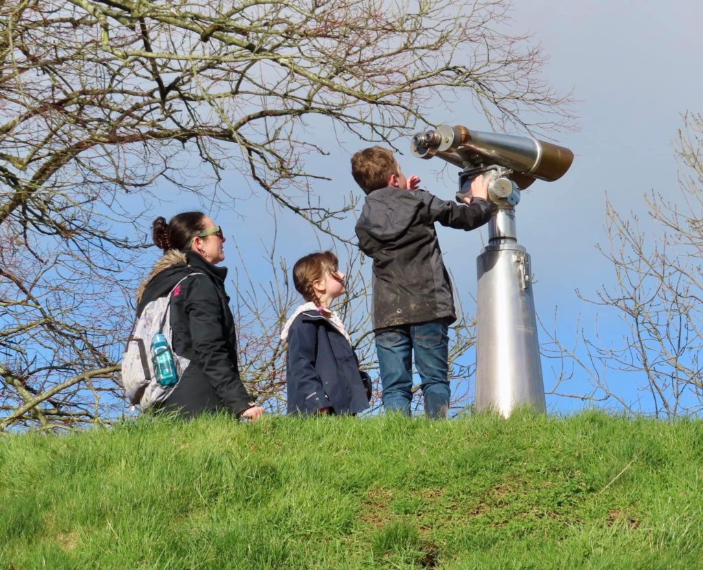 A family look through a telescope