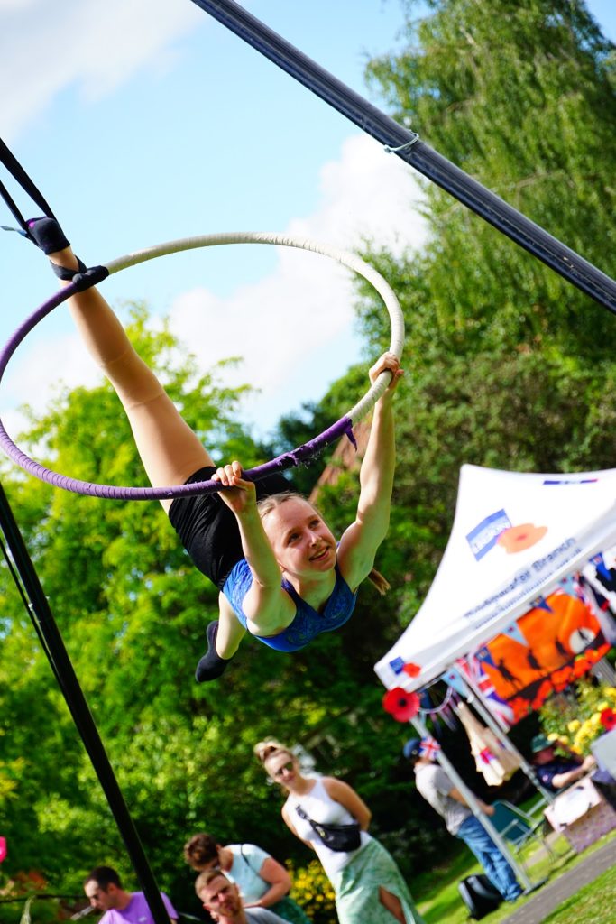 A gymnast performs at the quayside festival on a trapeze