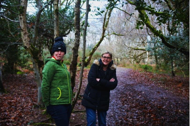 Two women smile on a cycle track