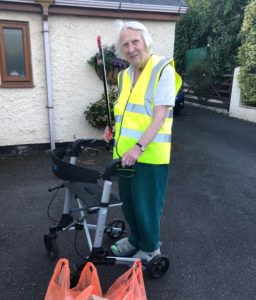 elderly lady collecting litter