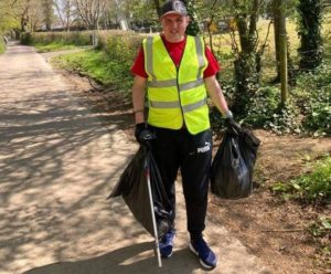 man picking up litter