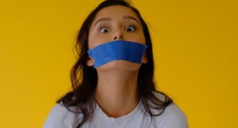 woman with blue tape on her mouth