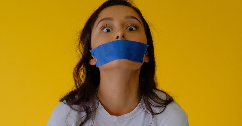 woman with blue tape on her mouth