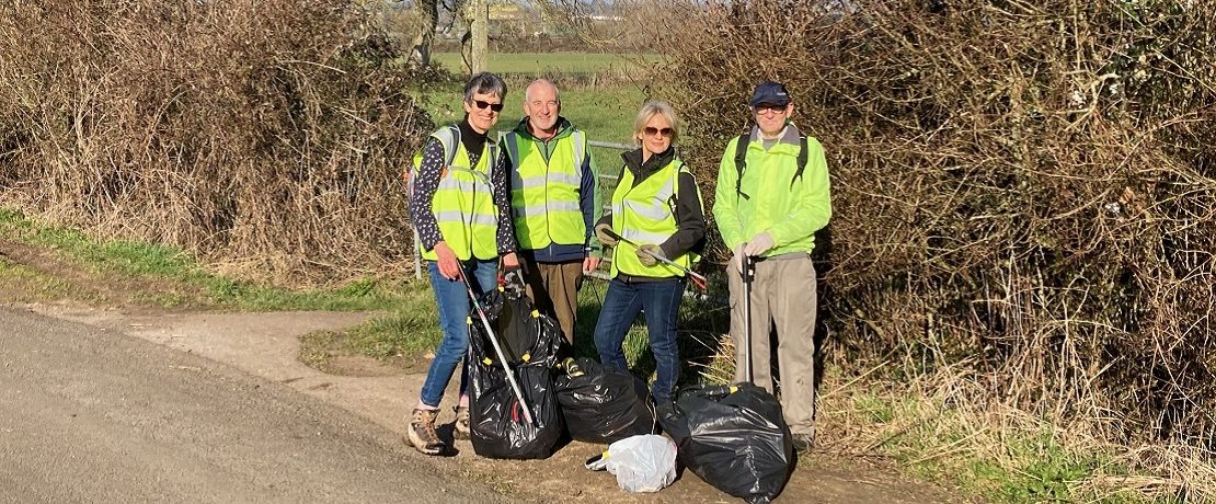 four people with litterpicking gear