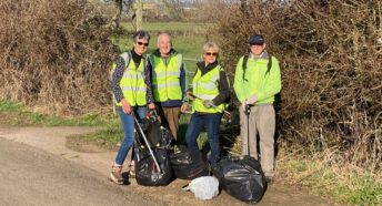 four people with litterpicking gear