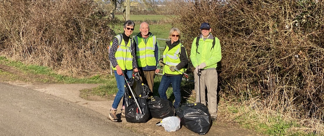 four people with litterpicking gear