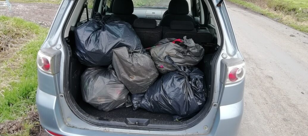 bags of rubbish in the boot of a car