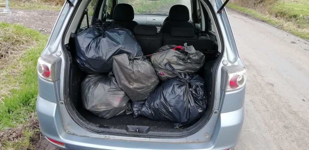 bags of rubbish in the boot of a car