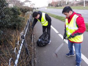 two young people litterpicking