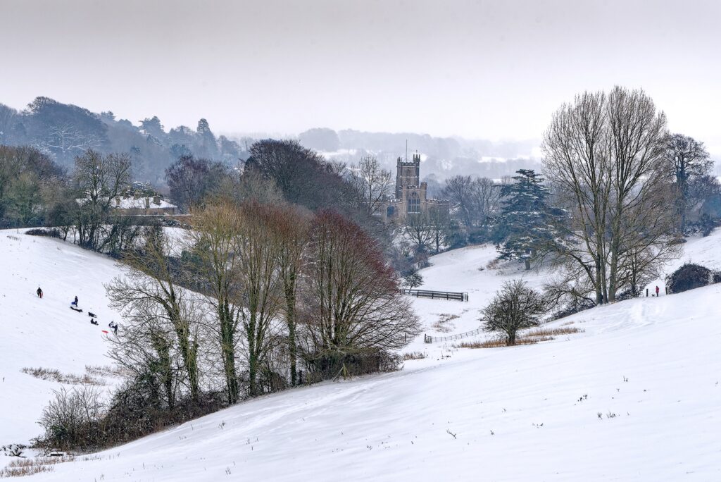 snowy scene with church and trees