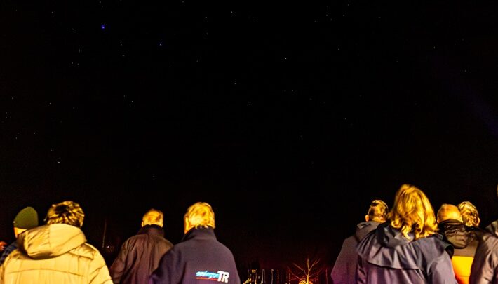 people looking at the night sky