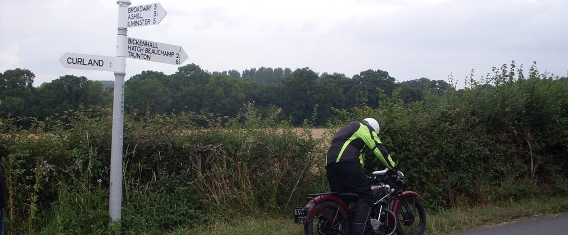 motorcyclist with fingerpost