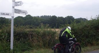 motorcyclist with fingerpost