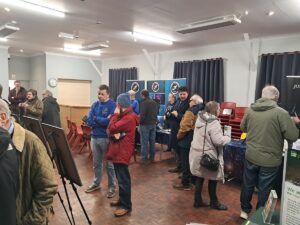 people in a village hall looking at displays
