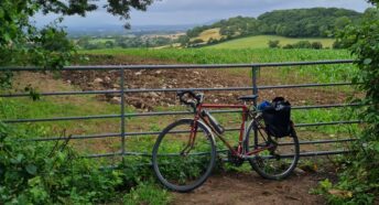 bike leaning against gatepost in countryside